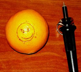 An orange that was marked with a wood burning tool.