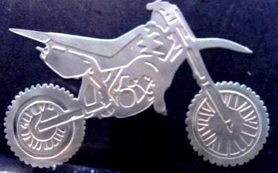 A picture of a dirtbike etched into thick glass.
