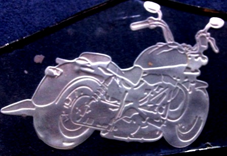 Etched motorcycle in glass with a two-stage sandcarving technique.