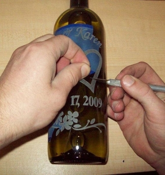 Removing and cleaning the stencil off the wine bottle
