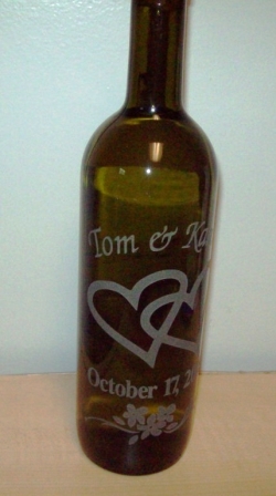 An etched glass wine bottle personalized for a wedding gift.