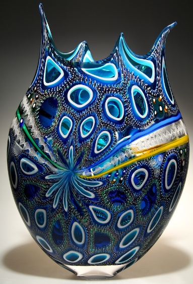 A blue murrine cane blown glass art with elegant designs.