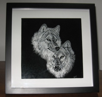 Engraved glass frame of wolves.