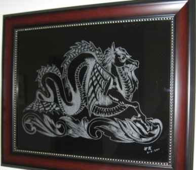 Engraving of a dragon by William K. on a framed glass art.