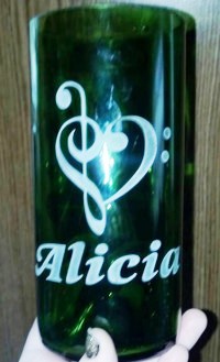 A heart clef and name personalized by etching into cut wine bottle.