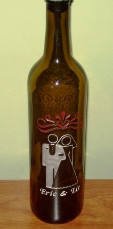 Wedding bottle design etched with silver paint and red coloring.