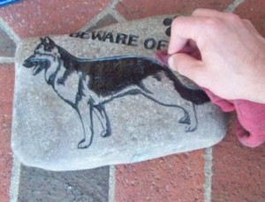 A picture of me cleaning a stone sandcarving after it was blasted and painted..