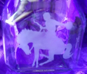 cowboy and horse etched on a jar