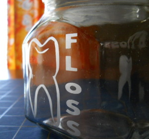 Dental jars etched with a tooth outline design.