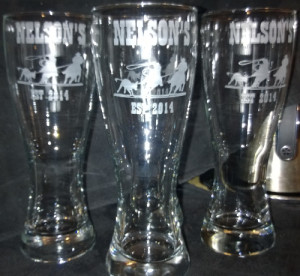 Pilsner glass etched with cowboy stencils.