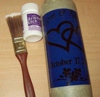 Glass bottle, cream, and brush.