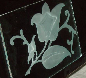 Three stage glass sandcarving project of a flower.