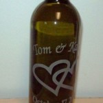 An etched glass wine bottle personalized for a wedding gift.