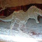 An dinosaur etched by sandcarver Kyle Hunter Goodwin.