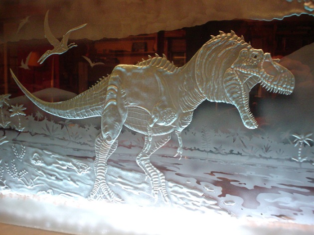 An dinosaur etched by sandcarver Kyle Hunter Goodwin.