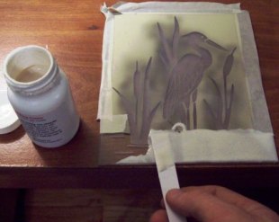 Adding cream to a sandblast etching.