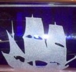 Sailboat etched on item similar to stained glass.