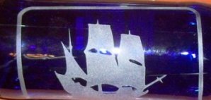 Sailboat etched on item similar to stained glass.