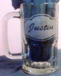 A non reusuable stencil etched glass beer mug.