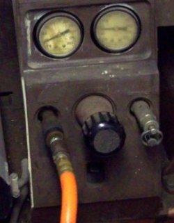 Adjustment gauges on compressor for air pressure settings.