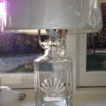 A fillable lamp etched with a shellfish.