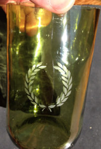 A completed etched glass bottle with Armour etch and Over n over stencils