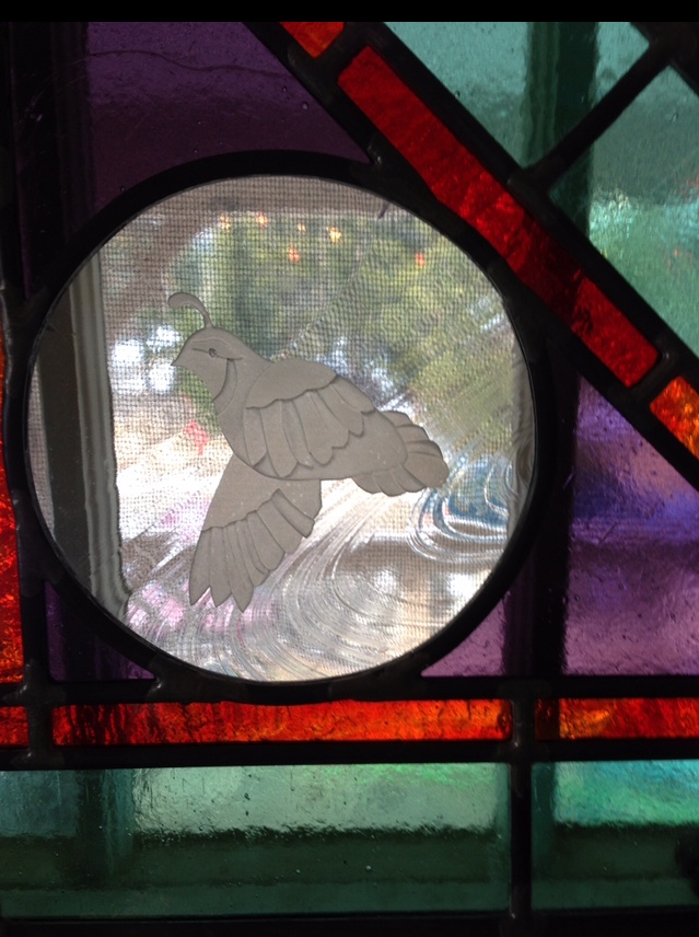 Stained glass with bird etching