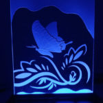 butterfly sandcarving on glass stand.