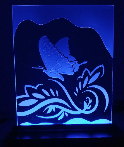 butterfly sandcarving on glass stand.