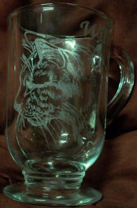 Hand stylus engraved cat on glass mug.
