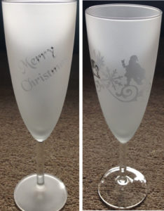 Merry Christmas and Santa etched on Champagne flutes.