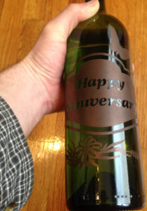 A colored and etched anniversary bottle