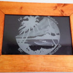 Custom frame etched glass of a boat and beach.