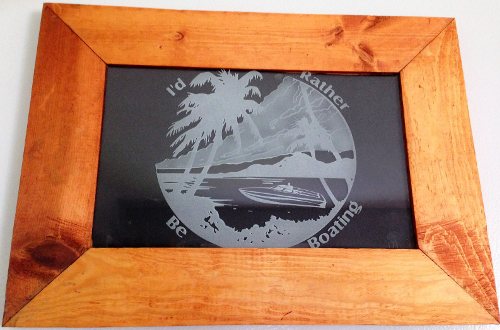 Custom frame etched glass of a boat and beach.