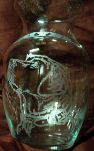 A dog design engraved on a flower vase.