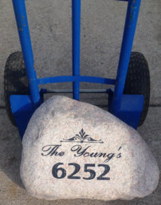 Dolly truck is used to move large rocks to sandblast site.