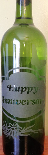 An etched wine bottle gift for an anniversary.