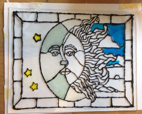 faux stained glass paint being applied in stages.