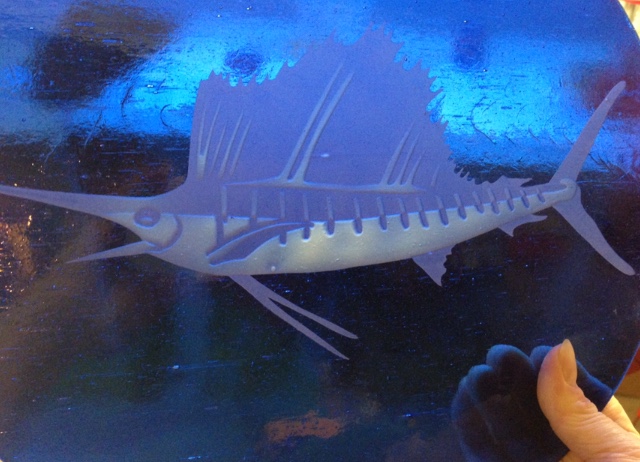 A marlin fish etched in blue Baroque Glass.