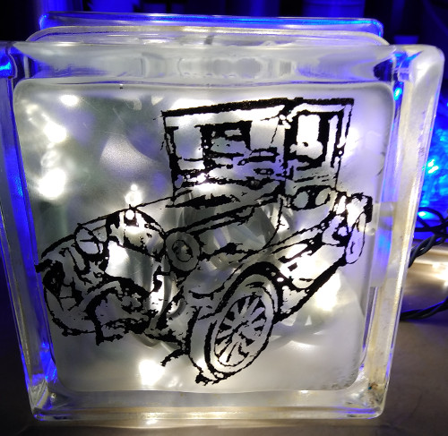 old fashioned car etched on glass block