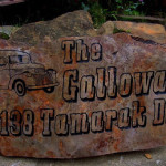 A personalized landscape rock sandblasted with address and name.