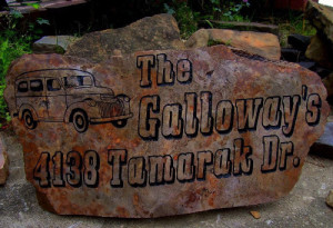 A personalized landscape rock sandblasted with address and name.