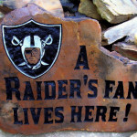 A fun Oakland Raiders fan engraves a design in rock.