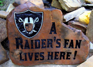 A fun Oakland Raiders fan engraves a design in rock.