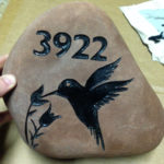 sandblast stone sign with address, flowers and hummingbird.