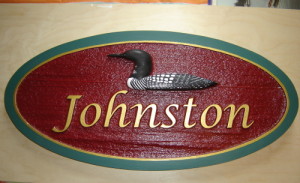 A wood sign sandblasted and painted.