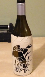 Example pattern cut out of stencil material and placed on bottle.