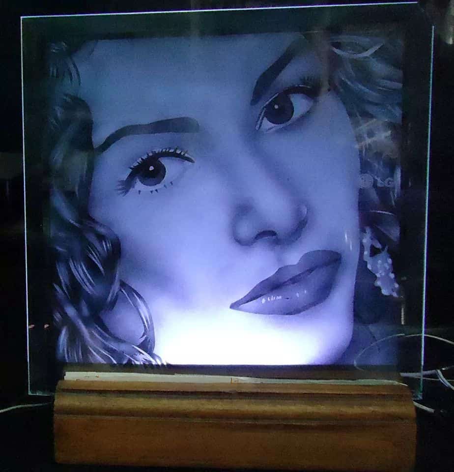 Model's face etched on glass and placed in a lighted base.